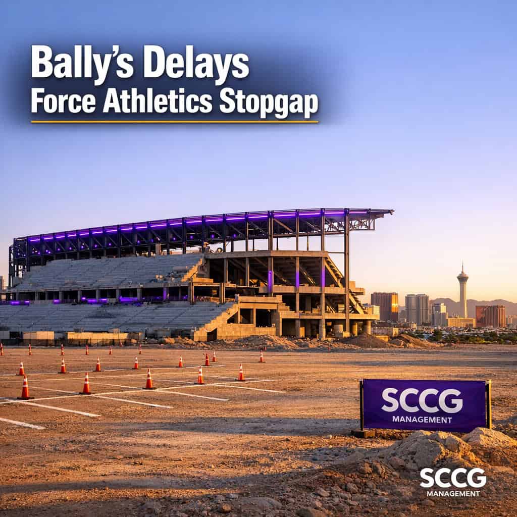 Half-built Las Vegas baseball stadium with a large empty dirt lot marked for temporary parking under bright golden-hour light.