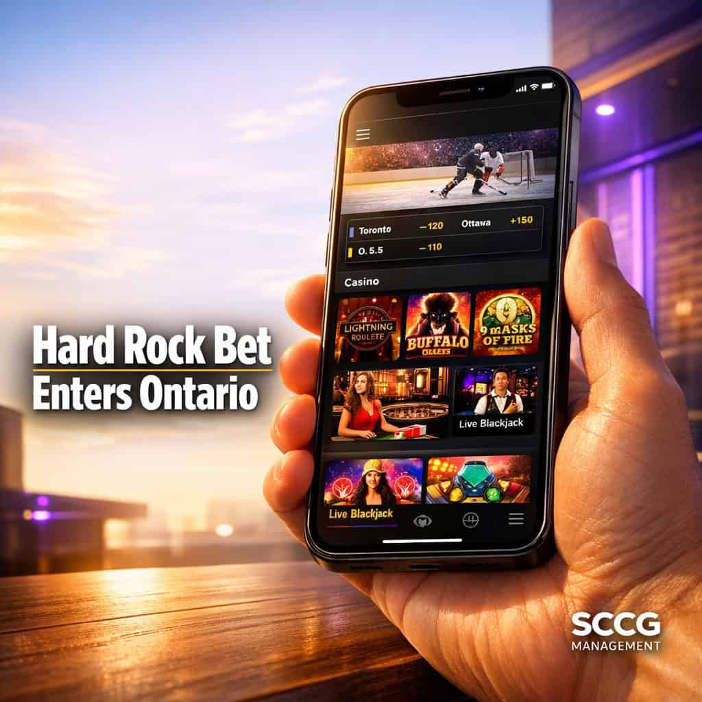 Sleek smartphone displaying the new Hard Rock Bet Ontario app with casino games and sports betting interface under dramatic studio lighting.
