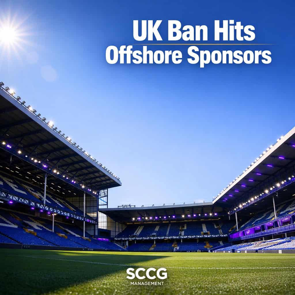Bright empty Premier League football stadium stands under clear blue sky conveying scale and regulatory impact.
