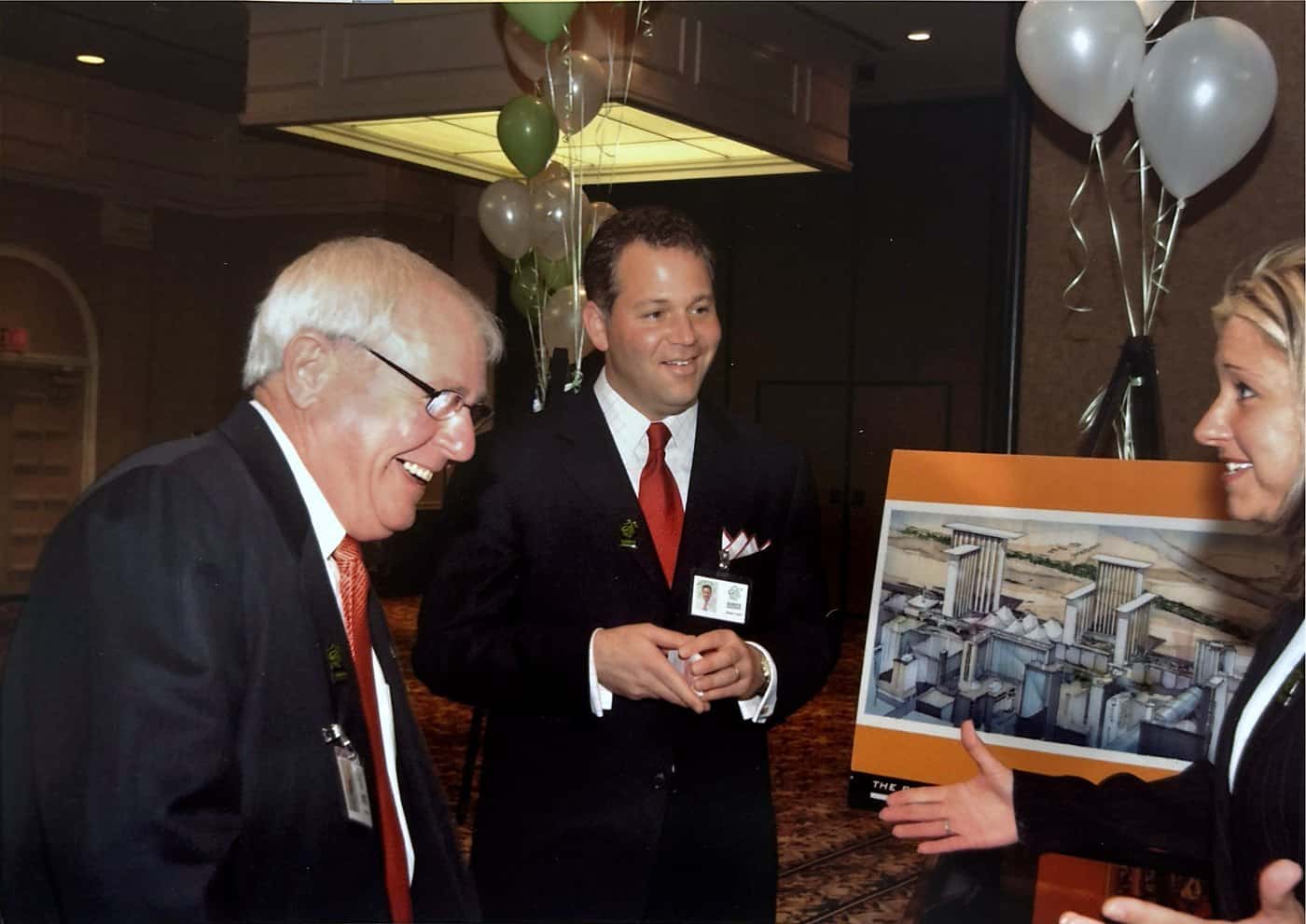Guests examining a framed architectural rendering of the downtown redevelopment.